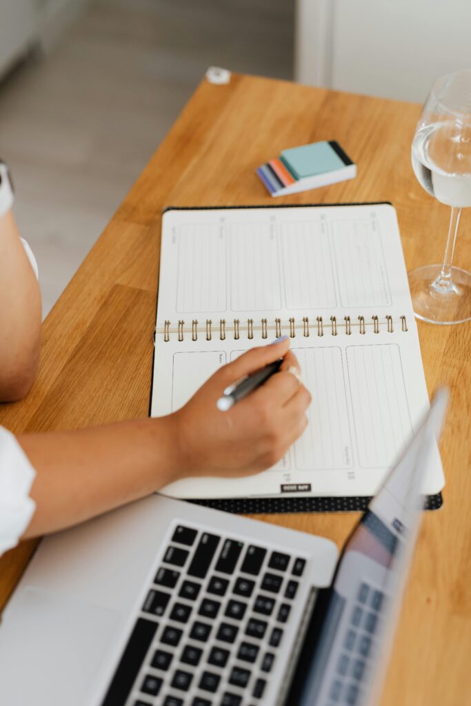 Person Writing on a Notebook